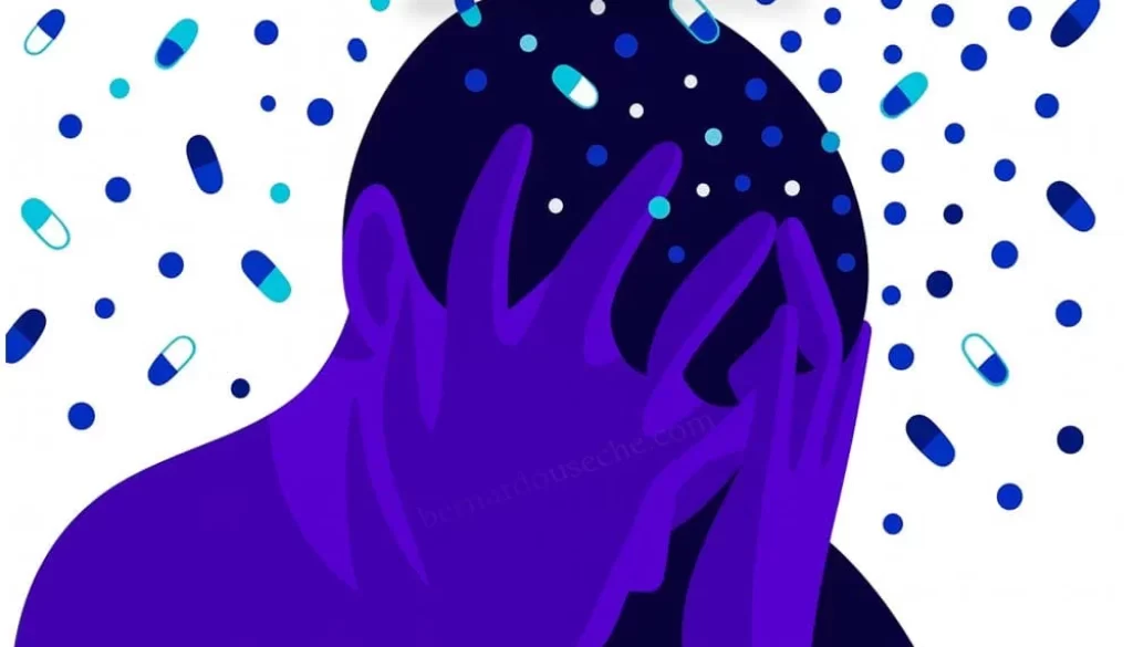 Ilustración de persona con la cabeza entre las manos rodeada de píldoras, símbolo de la salud mental en Colombia.